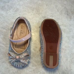 Doe a dear rhinestone and pearl dress shoe with a bow accent